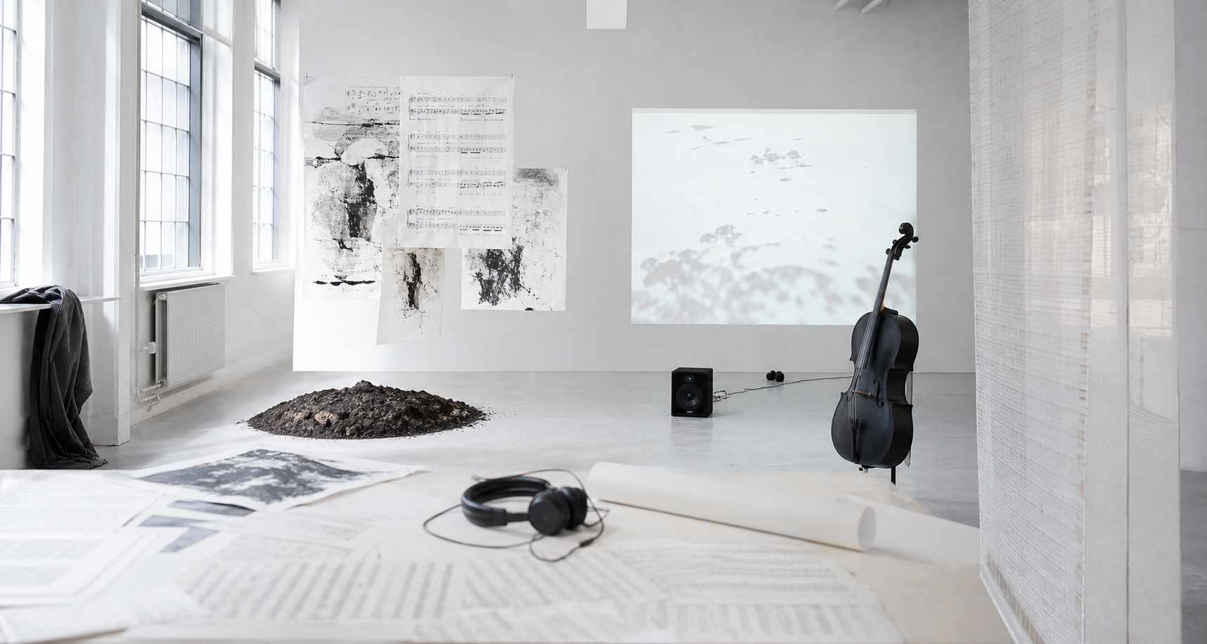 A minimal Nordic cultural workspace with materials for art, music and installation work.